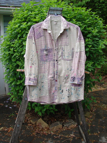 Magnolia Pearl Flannel Patched Surfside Shirt Sun Bleached OSFA draped on a wooden stepladder, showcasing its generous patching, hand distressing, paint splatters, button cuffs, and unique rear patch.