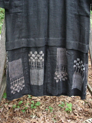 2000 Ringlet Dress Tulip Grass Black Altered Size 1 featuring oversized pockets, sectional panels, a V-shaped neckline, and daisy-themed hem, crafted from thick linen for a sophisticated, widening shape.