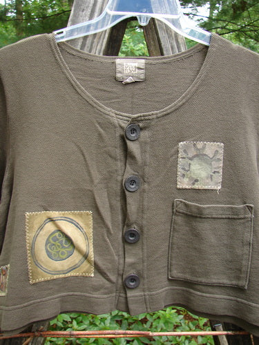 2000 Patched Recycle Jacket Science Bark Size 0, featuring a wide swing cut, rounded neckline, varied hemline, and colorful bio-themed patches with rubberized recycled buttons, perfect condition.