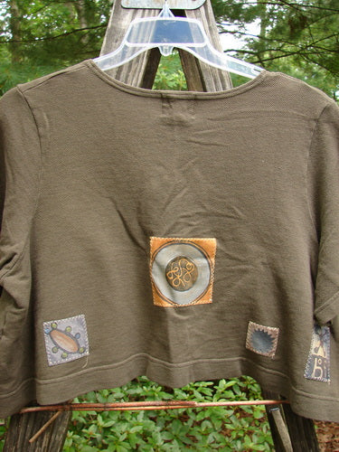 2000 Patched Recycle Jacket Science Bark Size 0 features a wide, swingy design with numerous colorful bio-themed patches, a feminine rounded neckline, and dark rubberized recycled buttons.