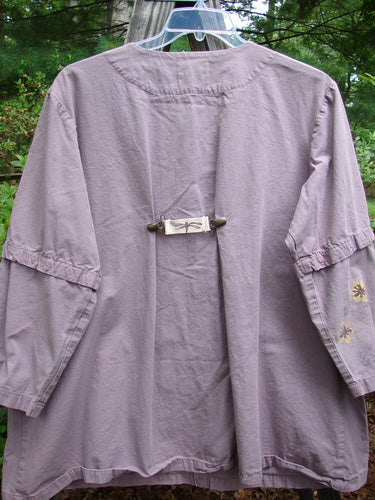 2000 Parachute Camper Jacket Florals Pale Purple Size 0, featuring a close-up of the sleeve, with a dragonfly motif and four front drop painted pockets.