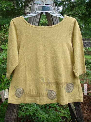 2000 Cotton Hemp Theo Top Center Gold Size 0 with three-quarter sleeves, rounded neckline, and A-line shape, displayed on a clothesline outdoors.