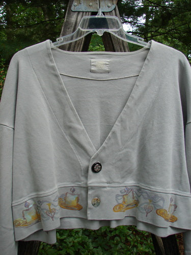 1999 Interlock Solstice Jacket Candle Blue Horizon Size 0, featuring wide belled sleeves, deep V neckline, and holiday-inspired design, displayed outdoors on a person.