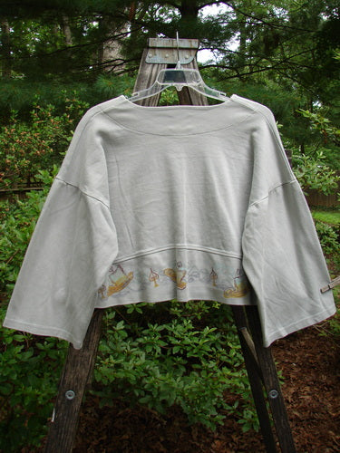 1999 Interlock Solstice Jacket Candle Blue Horizon Size 0 displayed on a mannequin, showcasing its super wide A-line shape, deep V neckline, belled sleeves, and holiday-inspired paint details.