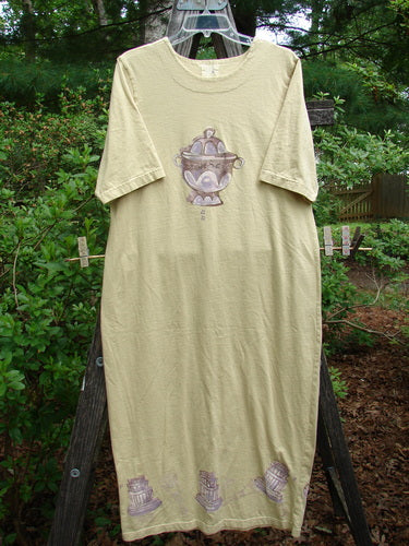 1999 Straight Dress Sugar Bowl Plantain Altered Size 1, displayed on a clothes rack, featuring two rounded side pockets, a rounded paneled neckline, and a narrowing vented hemline.