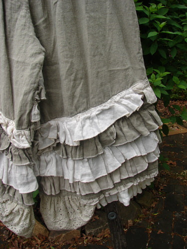 Magnolia Pearl Linen Eiffel Tower Bloomer Flaxen OSFA features layered ruffles with curly edges and eyelet lace on a dusty gray-green tiered skirt, embodying Bluefishfinder.com's vintage style.