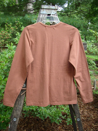 1997 Cotton Lycra Long Sleeved Layering Top Unpainted Copper Size 1 displayed on a hanger, showcasing a rounded shallow neckline, tapering waist, and slight lower flair.