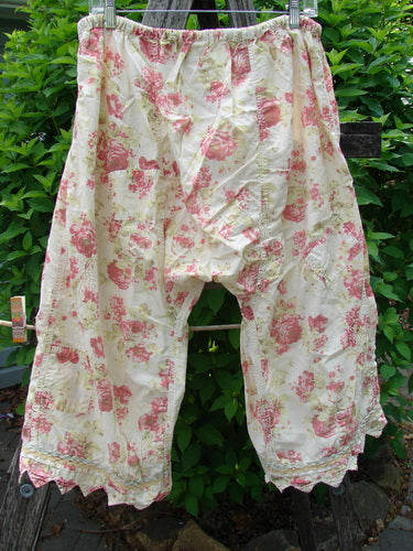 Magnolia Pearl Patched Khloe Bloomer Roses Are Red OSFA features pink floral print, hanging outdoors on a clothesline, showcasing vintage style with jester hems and hand-mended details.