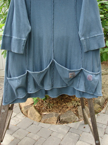 Barclay Patched Thermal Quad Drop Pocket Tunic Dress, Blue Tealen, Size 2, displayed on a wooden stand, highlighting its turtleneck, wide lower hem, and four drop pockets.