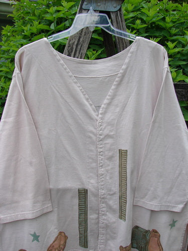 1993 Resort PJ Top Diner Treat Tea Dye Size 2 hangs on a clear hanger, showcasing its V-neck, elbow-length sleeves, and playful motifs, highlighting Bluefishfinder.com's unique vintage style.