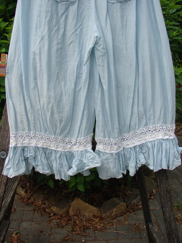 Magnolia Pearl Silk Voile Window Lace Ruffle Pocket Bloomer Sky OSFA: Knee-length cotton bloomers with white lace trim and ruffled hem, featuring elastic waist, multiple pockets, and ribbon tie accents.