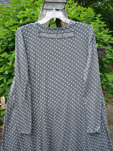 Magnolia Pearl Cotton Dylan Dress Ozzy Tiny Continuous Polka OSFA: Grey tunic with white polka dots, loose fit, raw seams, distressed details, and A-line flair, hanging outdoors on a clear hanger.