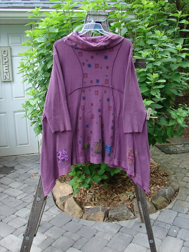 Barclay Patched Thermal Cowl Turtleneck Tunic Square Dusty Red Plum Size 2 on a rack showcasing its oversized pockets, curved exterior stitchery, and sectional panels.