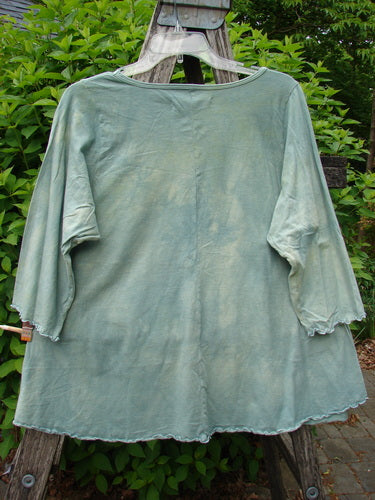 Barclay Three Quarter Sleeved Cafe Tee Owl Forest Mottled Mint Size 0, displayed on a wooden hanger, features a loose, A-line design with sweet curly edges and a rounded neckline.