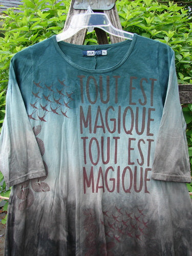 Barclay Wander Tunic Tee Magic Mottled Vintage Teal Size 0, featuring three-quarter sleeves, A-line flair, and bird silhouettes with TOUT EST MAGIQUE text, hanging on a clear plastic hanger.