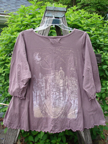 Barclay Crop A Lined Cafe Tee, featuring a forest scene with crescent moon, hangs on a ladder. Its rounded neckline and curly edgings reflect Bluefishfinder.com’s creative vintage style.