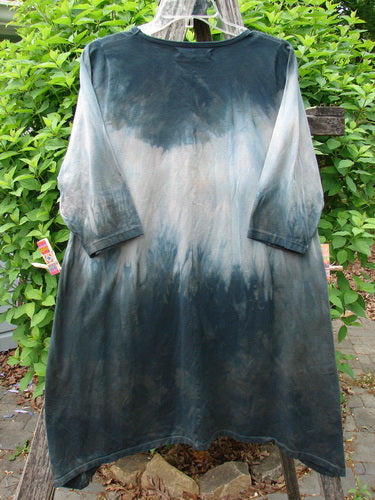 Barclay Wander Tunic Tee Rain Star Mottled Night Size 0 hangs on a clothesline. It features a tie-dye effect with three-quarter sleeves, a rounded neckline, and a slight A-line flair.