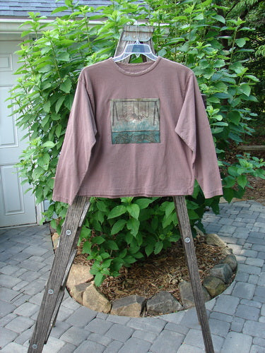1994 PMU Patched Long Sleeved Tee Rosewood Size 1 displayed on a wooden ladder, featuring a rolled neckline, cozy long sleeves, and playful patches in playground and cloud themes.
