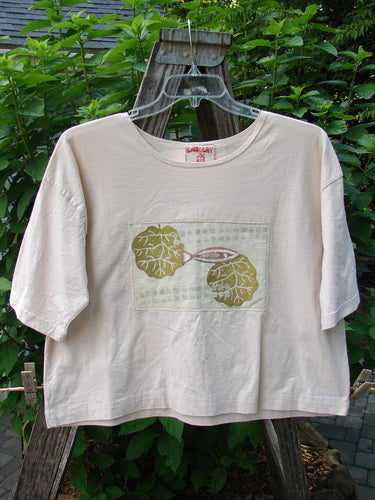 Barclay PMU Patched Short Sleeved Crop Tee Fish Creme Size 0 featuring a hand-stitched fish patch on lightweight organic cotton, showcasing a square boxy shape with short sleeves and a folded neckline.