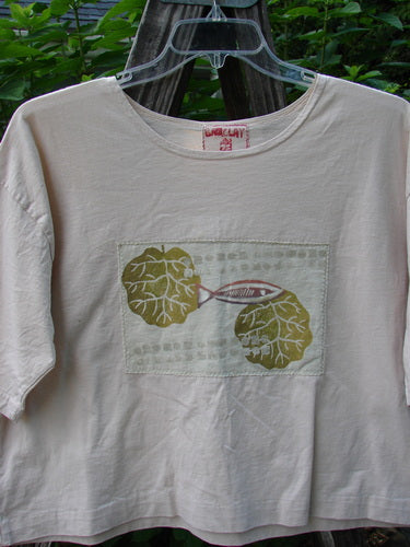 Barclay PMU Patched Short Sleeved Crop Tee Fish Creme Size 0, featuring a hand-stitched fish patch, short sleeves, square boxy shape, and folded neckline, made from lightweight organic cotton.