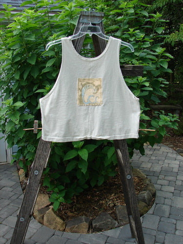 1999 PMU Patched Tank Top Wave Natural Size 1 displayed on a wooden stand, featuring a scooped neckline and colorful wave-themed patch, perfect for hot summer days.