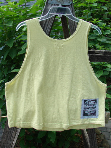 1999 NWT PMU Patched Tank Top Citron Size 0 displayed on a swinging hanger, featuring a scooped neckline and a colorful single fish patch, ideal for hot summer days.