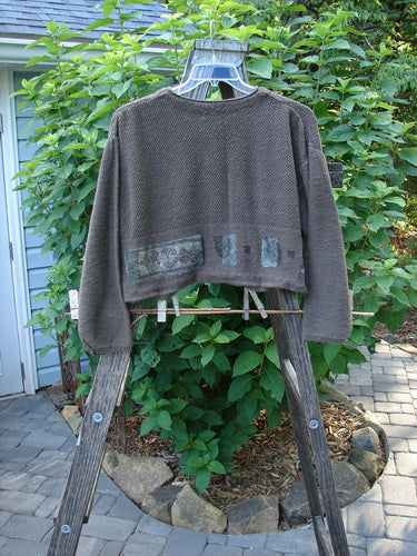 1994 Crop Cardigan Sweater Topiary Humus OSFA displayed on a wooden ladder with clothes pegs, showcasing its textured knit, dual contrasting stitches, and distinctive stoneware buttons. Cozy, vintage piece from Bluefishfinder.com.