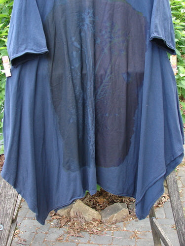 Barclay Origami Tunic Top Night Garden Blue Ink Size 0 hangs outdoors, showcasing its unique widening design, open sides, oval neckline, and raw flutter edges, clipped on a drying frame.