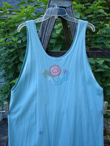 Barclay Scoop Front River Journey Dress in Blue Tourmaline on a hanger, showcasing deep scoop neckline, straight elongating shape, fancy floral theme paint, and upward scoop front hemline in altered size 1.