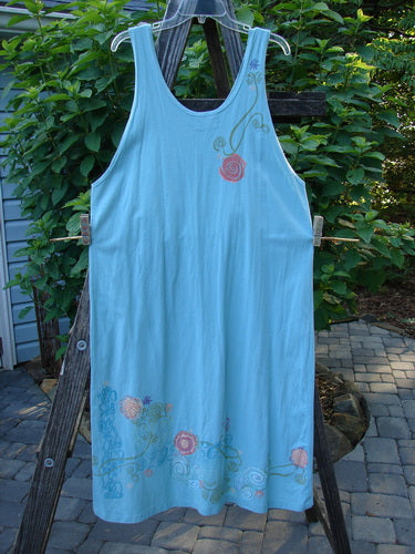 Barclay Scoop Front River Journey Dress Fancy Floral Blue Tourmaline Altered Size 1 displayed on a wooden ladder, showcasing its deep scoop neckline, straight shape, and floral design.