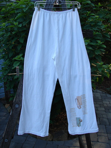 A pair of 2001 Cotton Lycra Matchstick Pants Junk Drawer Fizz Size 1, featuring a thin waistband and wide bottoms, hanging on a clothesline.