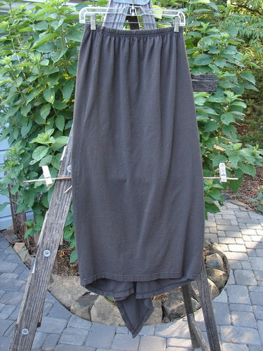 1994 Harvest Gather Skirt Unpainted Bark Size 1 displayed on a wooden rack, showcasing its sectional panels and replaced elastic waistband for adjustable length.