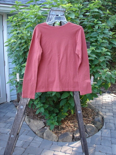 Barclay Cotton Lycra Long Sleeved Layering Top Unpainted Brick Size 1 displayed on a hanger, showcasing its rounded neckline and longer sleeves.