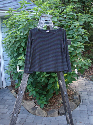 2000 Rayon Lycra Rib Long Sleeved Layering Top Unpainted Burgundy Stripe Size 1, displayed on a wooden ladder, showcasing its rounded neckline, long sleeves, and A-line shape.