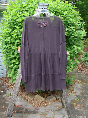 Barclay Patched Cotton Mesh Exterior Stitch Sectional Overtop Black Cherry Size 2, displayed on a hanger over a wooden stepladder outdoors, highlighting its long sleeves and textured cotton mesh design.