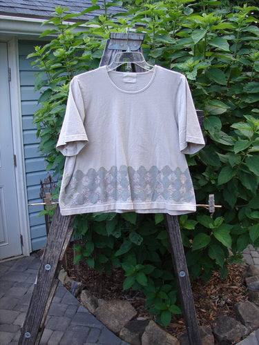 2000 Short Sleeved Crop Tee Floral Fence Dove Size 0 displayed on a hanger, showcasing its wide crop box shape, sweet floral fence theme, and wider, flat finished neckline.