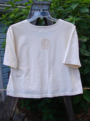 2001 Button Crop Top Pawn Natural Size 0 hanging on a clothesline, showcasing its boxy style, wide short sleeves, and unique chess game theme paint.