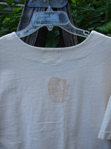 2001 Button Crop Top Pawn Natural Size 0 featuring a slightly deeper rounded neckline, wide short sleeves, and a unique chess game theme paint. Noticeable spot on the lower front side.