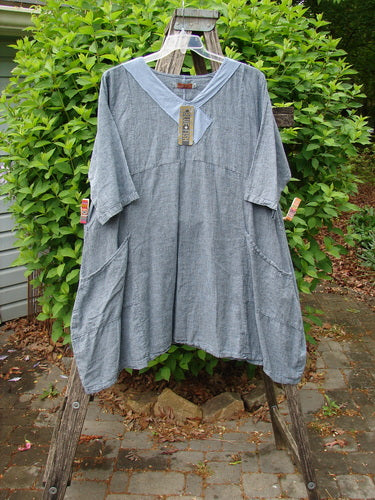 Barclay NWT Linen Cross Over Urchin Dress Unpainted Stripe Sky Size 1 hanging on ladder, featuring a V-neckline, drop shoulders, and patch pockets, embodying Bluefishfinder.com's vintage-inspired, creative style.