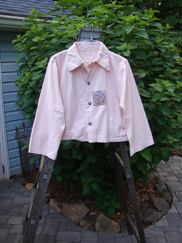 2001 Patched Licorice Jacket Pink Tile Size 0 displayed on a wooden ladder, showcasing its 4 metal buttons, slight A-line shape, and tailored back with small vented sides.
