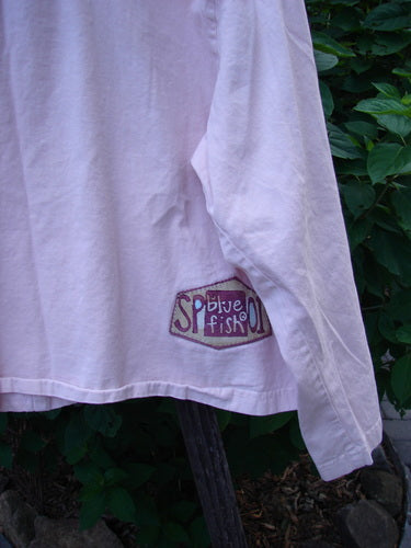 Close-up of the 2001 Patched Licorice Jacket in Pink Tile, featuring metal buttons, slight A-line shape, and tailored back, showcasing the jacket's intricate details and fine craftsmanship.