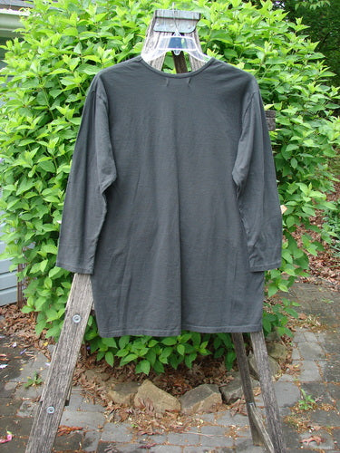 Barclay NWT Long Sleeved Studio Tee Celtic Medallion Smoke Size 0 draped over a wooden ladder, showcasing its straight shape, rounded neckline, and distinctive Celtic medallion design, embodying BlueFishFinder's vintage aesthetic.