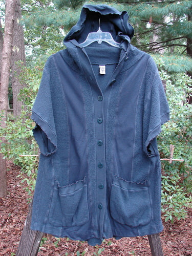 Barclay Celtic Moss Hooded Pocket Cardigan Unpainted Navy Storm Size 0 displayed on a hanger, showcasing its floppy hood, short sleeves, exterior pockets, and full button front with curly edgings.