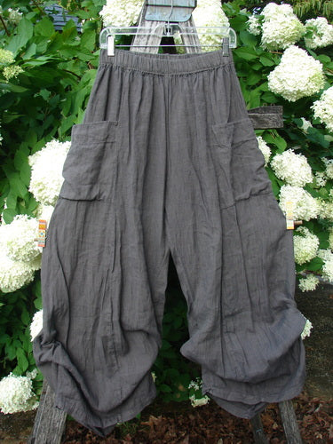 Bluefishfinder.com Barclay Linen Tie Bottom 4 Square Pant Cross Dye Army Unpainted Size 0 in cross-dyed army gray linen, with a loose, cropped silhouette and tie hems gathered into rounded cuffs. Four square patch pockets and a softly textured weave stand out against the leafy outdoor backdrop.
