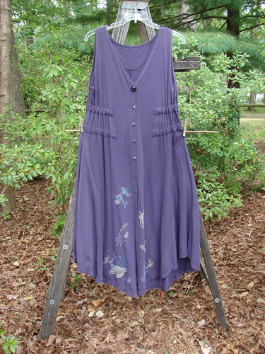 1994 Spin Jumper Mixed Purple Nuit Size 2 displayed on a clothesline, showcasing a deep V-neckline, longer arm openings, and sweeping hemline with intricate leaf and vine paint details.
