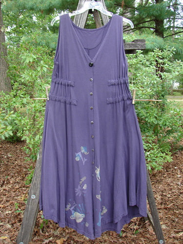 1994 Spin Jumper Mixed Purple Nuit Size 2, displayed on a clothesline, featuring a sweeping hemline with an upward curve, double side back wrap drawcords, and intricate leaf and vine patterns.