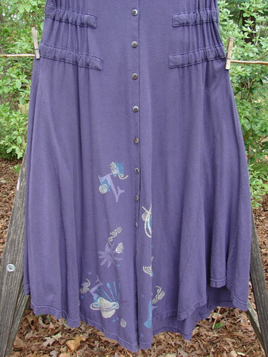 1994 Spin Jumper Mixed Purple Nuit Size 2 displayed on a clothesline, showcasing its sweeping hemline, horizontal tie tunnels, and intricate leaf and vine patterns, reflecting vintage Blue Fish Clothing's creative and expressive style.