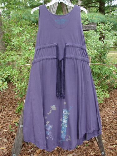 1994 Spin Jumper Mixed Purple Nuit Size 2, displayed on a clothesline, featuring intricate leaf and vine patterns, double side back wrap drawcords, and a sweeping hemline with upward curves.
