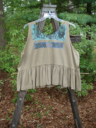 1992 Peplum Top Beetle Wheat OSFA displayed on a wooden ladder, featuring a blue beetle design and a flounced bottom, capturing the vintage essence of Blue Fish Clothing's Summer Collection.