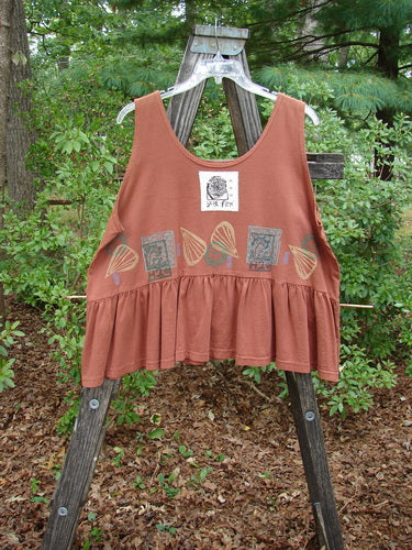 1992 Peplum Top Beach Sienna OSFA displayed on a wooden rack, showcasing a wide yoke waist, rounded neckline, high arm openings, gathered flounce, and vintage beach-themed graphic design.